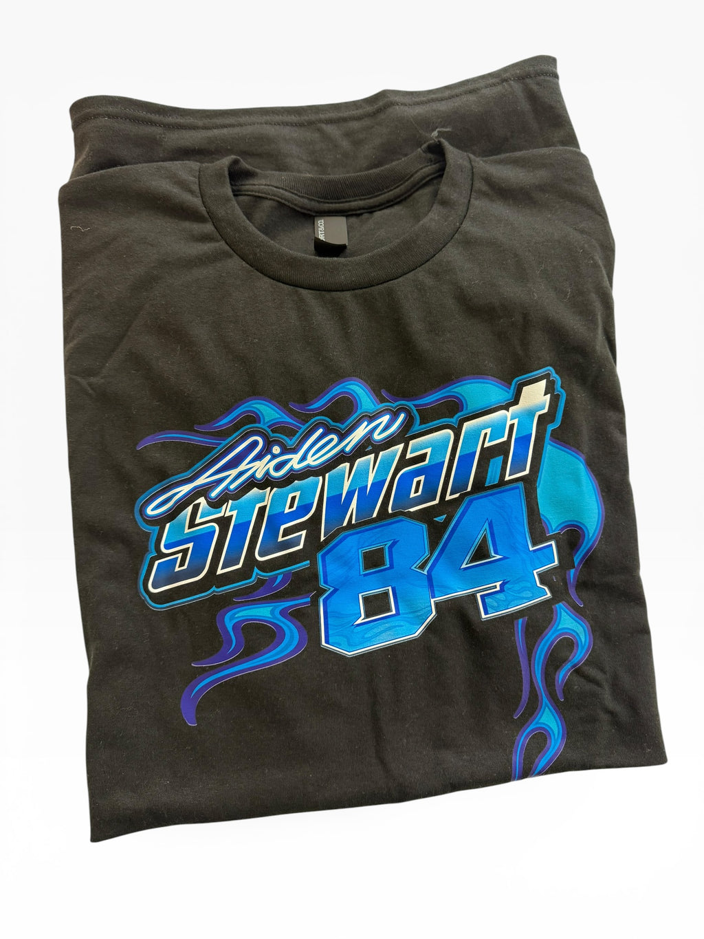Folded black t-shirt with blue and white graphic design on a white background