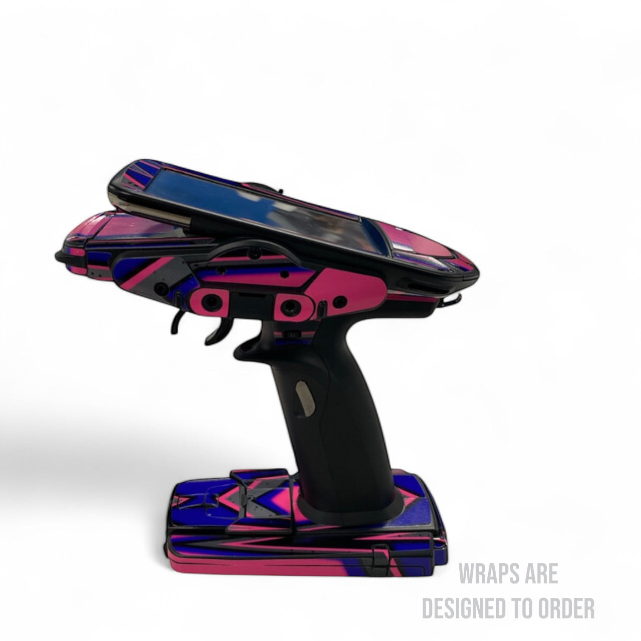Colorful remote control with pink and blue design on a white background