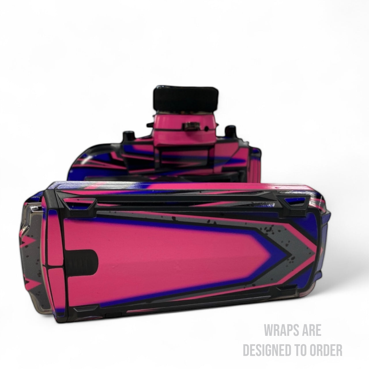 Pink and black rc controller with geometric design on a white background