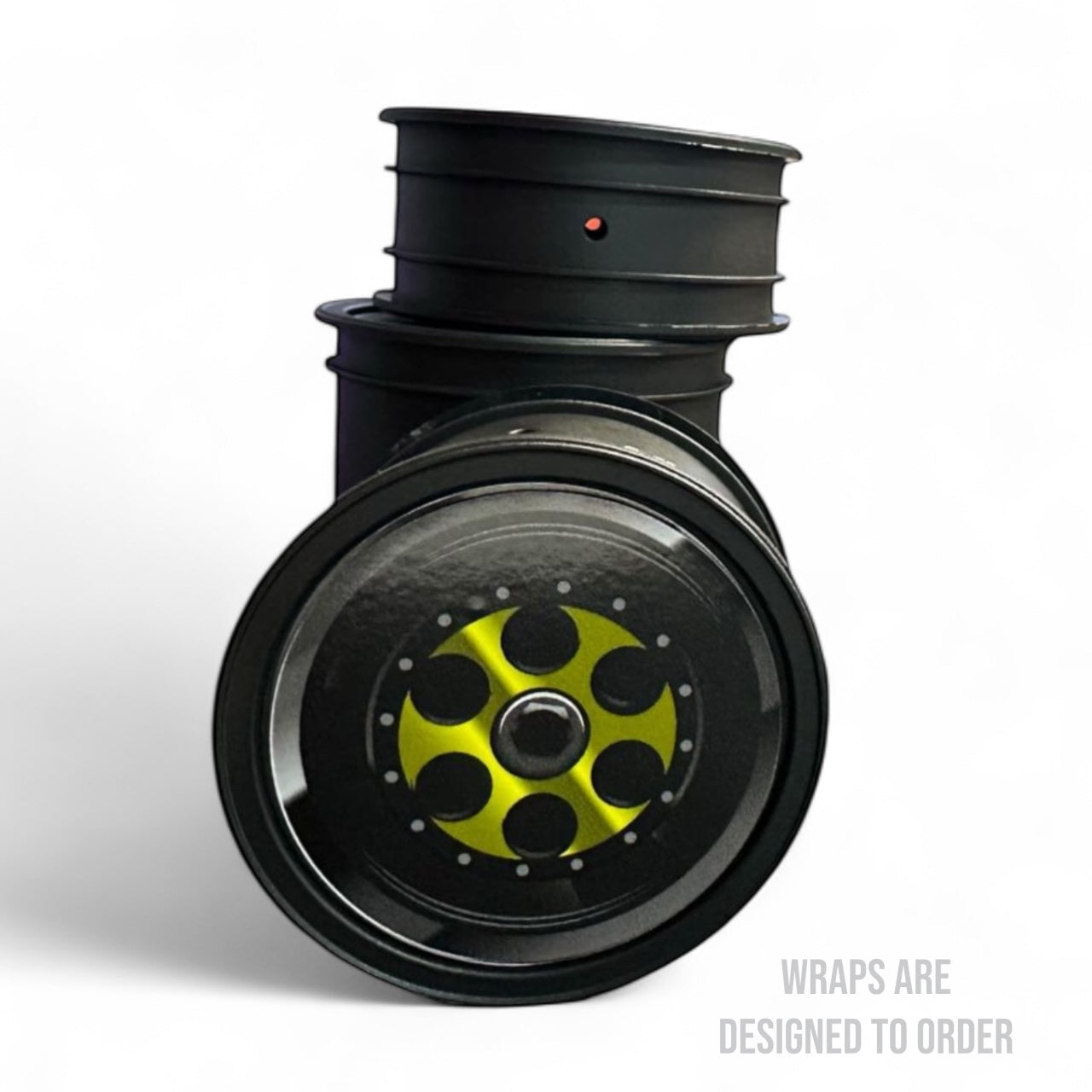 Black car wheel with yellow hubcap on a white background